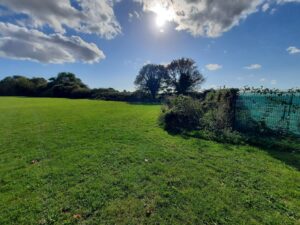 Image shows Dane Valley park in Margate, on a sunny day with blue sky and white clouds.